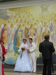 28278 Newly weds by mural at St. Michael's golden domed cathedral.jpg